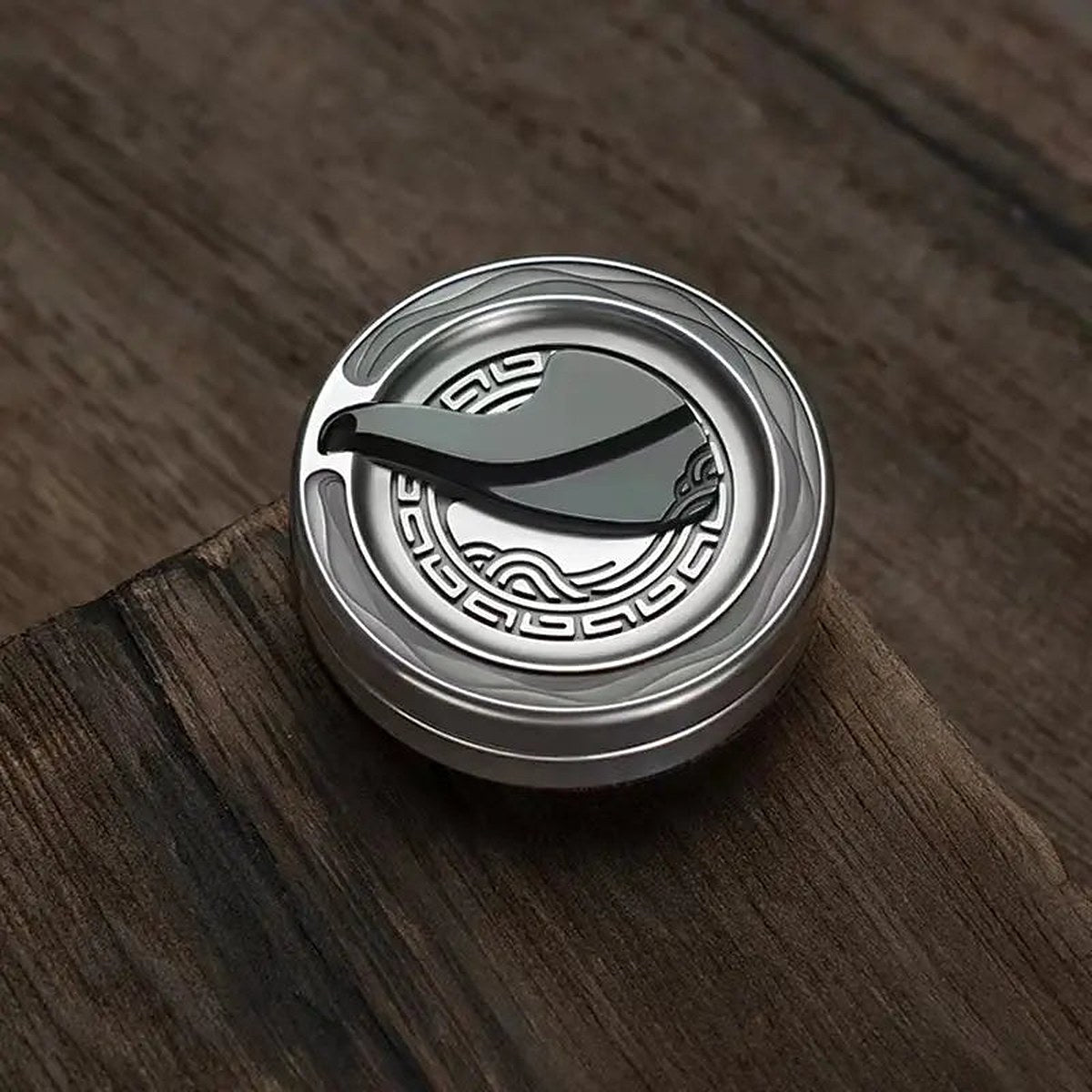 Anchor Coin stainless steel on a walnut desk