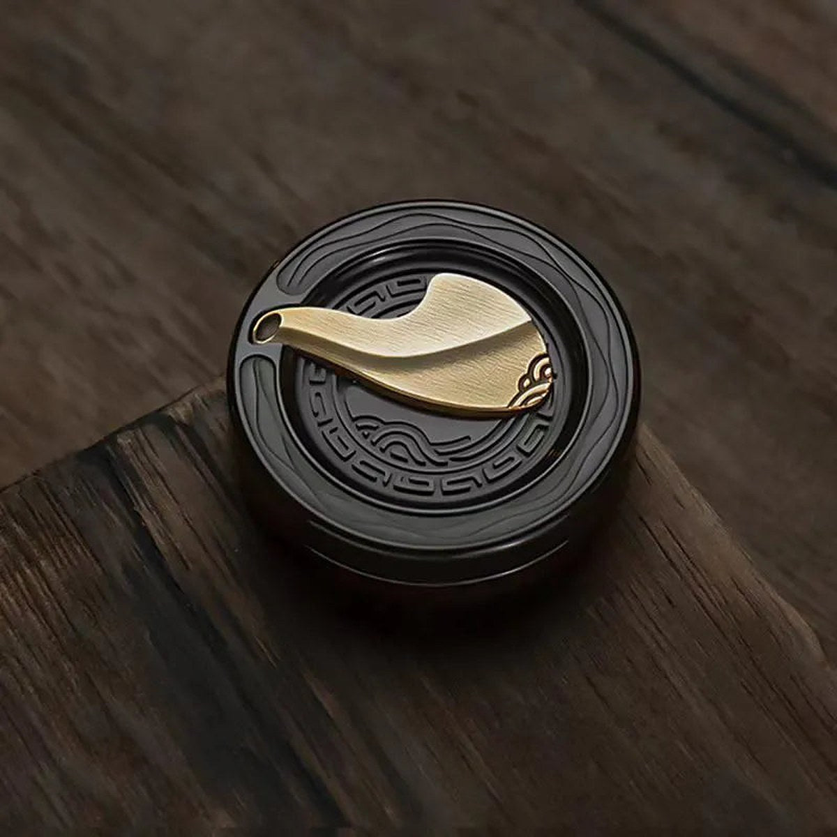 Anchor Coin zirconium on a walnut desk